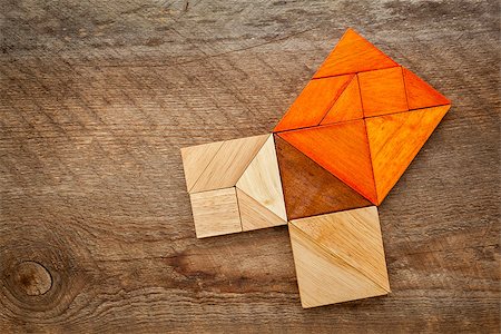 simsearch:400-07774007,k - Pythagorean theorem illustrated with wooden pieces of tangram, a classic Chinese puzzle, against barn wood background Foto de stock - Royalty-Free Super Valor e Assinatura, Número: 400-07179240