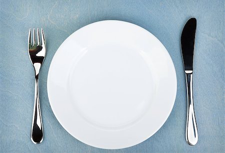 restaurant in blue with table setting - Empty white plate with silverware on blue wooden table Stock Photo - Budget Royalty-Free & Subscription, Code: 400-07179369