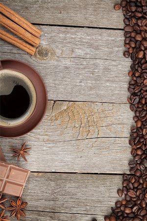 simsearch:400-04849433,k - Coffee cup, spices and chocolate on wooden table texture with copy space. View from above Photographie de stock - Aubaine LD & Abonnement, Code: 400-07179468