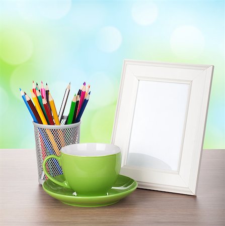 simsearch:400-07465112,k - Photo frame, coffee cup and colorful pencils on wood table over sunny day bokeh background Stock Photo - Budget Royalty-Free & Subscription, Code: 400-07179655