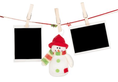 film on strings with clothing pin - Two blank photos and snowman hanging on the clothesline. Isolated on white background Stock Photo - Budget Royalty-Free & Subscription, Code: 400-07179669