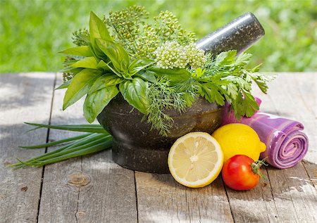 simsearch:400-04348087,k - Fresh herbs in mortar on garden table Stock Photo - Budget Royalty-Free & Subscription, Code: 400-07179765