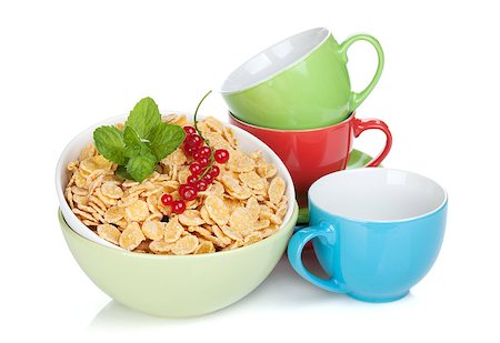 simsearch:400-05735704,k - Fresh corn flakes with currant and colorful cups. Isolated on white background Photographie de stock - Aubaine LD & Abonnement, Code: 400-07179760
