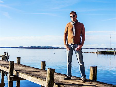 picture of land beach resort - Man with sunglasses on a landing stage at a lake in sunny weather Stock Photo - Budget Royalty-Free & Subscription, Code: 400-07179841