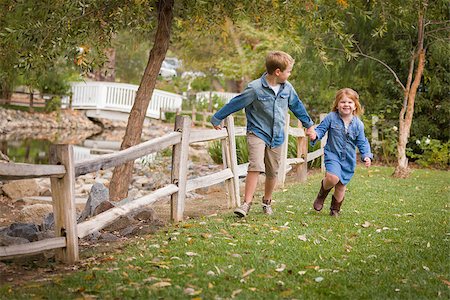 simsearch:400-04568360,k - Happy Young Brother and Sister Running Together Outside. Foto de stock - Super Valor sin royalties y Suscripción, Código: 400-07179928