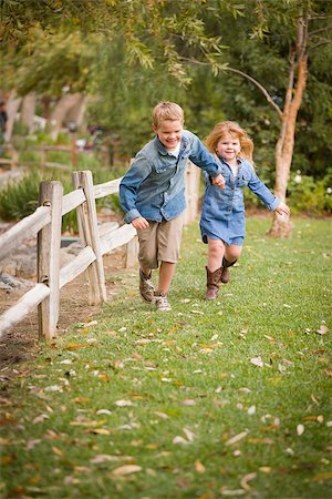 simsearch:400-04568360,k - Happy Young Brother and Sister Running Together Outside. Foto de stock - Super Valor sin royalties y Suscripción, Código: 400-07179929