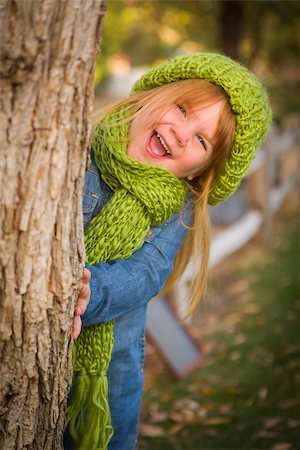 feverpitched (artist) - Cute Smiling Young Girl Wearing Green Scarf and Hat Posing for a Portrait Outside. Stock Photo - Budget Royalty-Free & Subscription, Code: 400-07179950