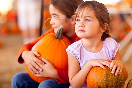 simsearch:400-07169847,k - Cute Little Girls Holding Their Pumpkins At A Pumpkin Patch One Fall Day. Photographie de stock - Aubaine LD & Abonnement, Code: 400-07170165