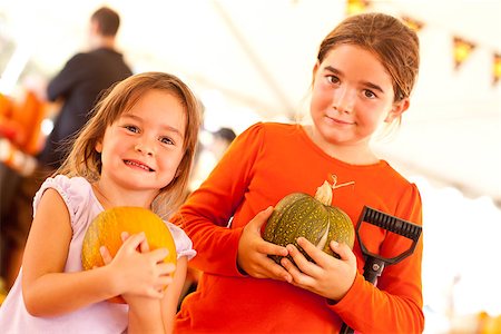 simsearch:400-07169847,k - Cute Little Girls Holding Their Pumpkins At A Pumpkin Patch One Fall Day. Photographie de stock - Aubaine LD & Abonnement, Code: 400-07170168