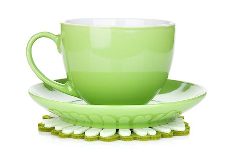 simsearch:400-06461761,k - Green coffee cup on napkin.Isolated on white background Fotografie stock - Microstock e Abbonamento, Codice: 400-07172540