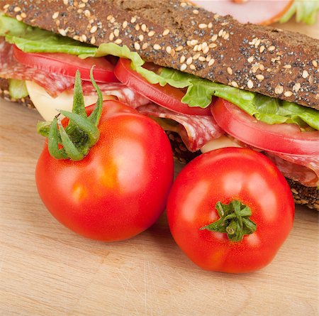 simsearch:400-07179775,k - Ripe tomatoes and sandwich on wood table Stock Photo - Budget Royalty-Free & Subscription, Code: 400-07172595
