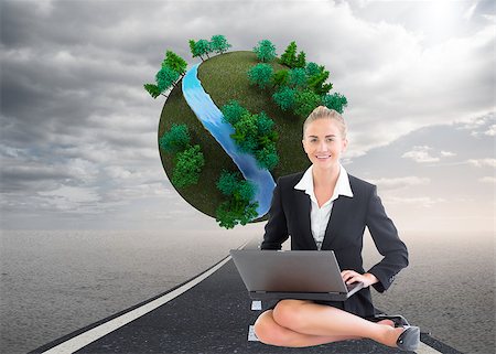 Composite image of blonde businesswoman using laptop Stock Photo - Budget Royalty-Free & Subscription, Code: 400-07186211