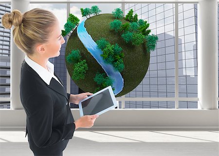female business woman holding ball - Composite image of blonde businesswoman holding new tablet Stock Photo - Budget Royalty-Free & Subscription, Code: 400-07186549