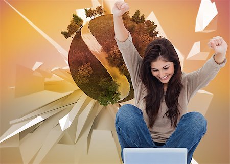 Composite image of pretty brunette cheering while using laptop Stock Photo - Budget Royalty-Free & Subscription, Code: 400-07186854