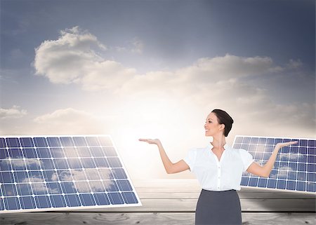 solar panels business - Composite image of happy elegant businesswoman posing Stock Photo - Budget Royalty-Free & Subscription, Code: 400-07187047