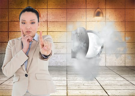 Composite image of thoughtful asian businesswoman pointing Stock Photo - Budget Royalty-Free & Subscription, Code: 400-07187570