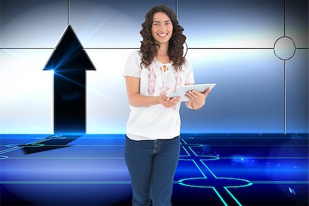 simsearch:400-07189587,k - Composite image of smiling casual brunette using her tablet pc Stockbilder - Microstock & Abonnement, Bildnummer: 400-07188993