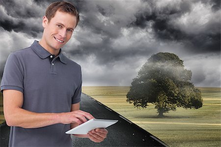 simsearch:400-06889355,k - Composite image of smiling young man with tablet computer Stockbilder - Microstock & Abonnement, Bildnummer: 400-07189110