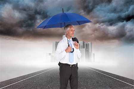 Composite image of happy mature businessman holding umbrella Stock Photo - Budget Royalty-Free & Subscription, Code: 400-07189224