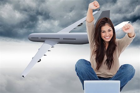 Composite image of a woman celebrating in front of her laptop as she smiles looking forward. Stock Photo - Budget Royalty-Free & Subscription, Code: 400-07189774