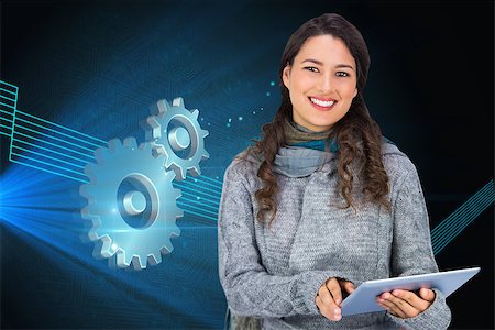 female mechanic clothing - Composite image of smiling model wearing winter clothes holding her tablet Stock Photo - Budget Royalty-Free & Subscription, Code: 400-07189923