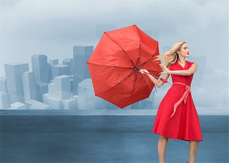 Composite image of beautiful woman posing with a broken umbrella with her leg raised Stock Photo - Budget Royalty-Free & Subscription, Code: 400-07189988