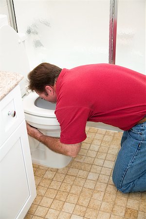 Man kneeling down in the bathroom, vomiting into the toilet. Stock Photo - Budget Royalty-Free & Subscription, Code: 400-07180000