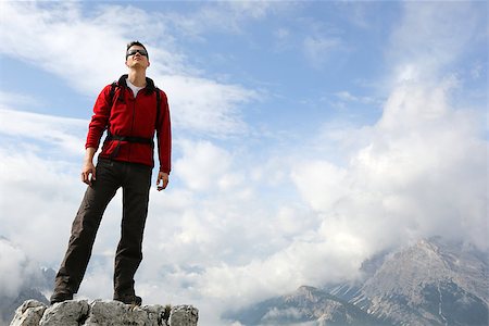 Young mountaineer standing on a mountain top and enjoying freedom in the mountains Stock Photo - Budget Royalty-Free & Subscription, Code: 400-07180033