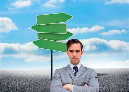 simsearch:400-07275251,k - Composite image of young businessman looking at camera in front of road sign and sky background Stock Photo - Budget Royalty-Free & Subscription, Code: 400-07180160