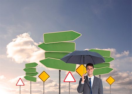 Composite image of happy businessman holding umbrella standing in front of road signs in the sky Stock Photo - Budget Royalty-Free & Subscription, Code: 400-07180244