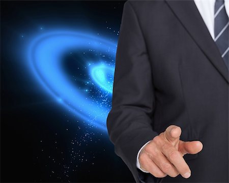 simsearch:400-04861869,k - Composite image of businessman in suit pointing finger on blue galaxy background Foto de stock - Royalty-Free Super Valor e Assinatura, Número: 400-07180476