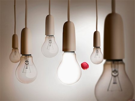simsearch:400-07220428,k - Composite image of red apple being thrown between light bulbs hanging from ceiling Stock Photo - Budget Royalty-Free & Subscription, Code: 400-07180515