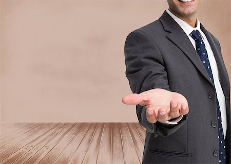 simsearch:400-07665425,k - Composite image of businessman showing his empty hand standing in brown room Stockbilder - Microstock & Abonnement, Bildnummer: 400-07180615