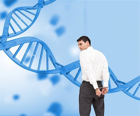 dna and businessman - Composite image of businessman wearing handcuffs in front of dna spiral Stock Photo - Budget Royalty-Free & Subscription, Code: 400-07180611