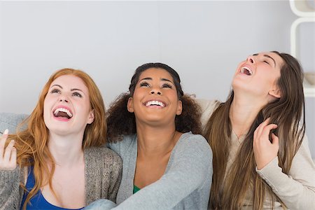 simsearch:400-07181183,k - Cheerful young female friends laughing out loud at home Photographie de stock - Aubaine LD & Abonnement, Code: 400-07181119