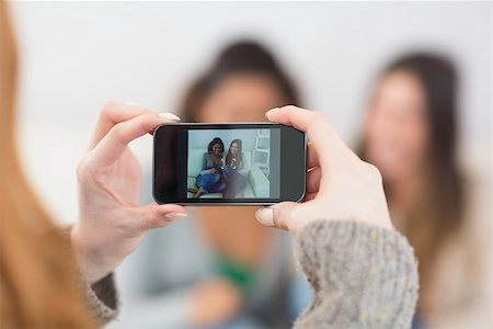 simsearch:400-07181183,k - Close up of a woman photographing friends with smartphone at home Photographie de stock - Aubaine LD & Abonnement, Code: 400-07181142