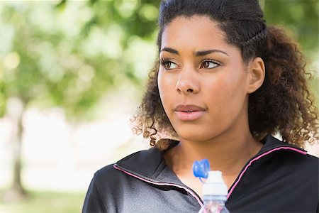 Close up of a tired healthy young woman with water bottle in the park Stock Photo - Budget Royalty-Free & Subscription, Code: 400-07181205