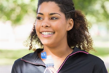 Close up of a smiling tired healthy young woman with water bottle in the park Stock Photo - Budget Royalty-Free & Subscription, Code: 400-07181206