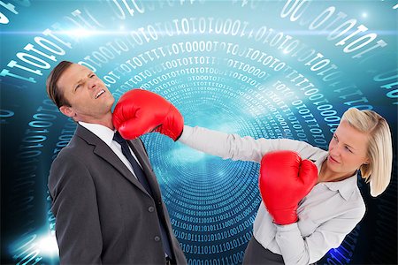 simsearch:400-07189305,k - Composite image of businesswoman hitting colleague with her boxing gloves Stock Photo - Budget Royalty-Free & Subscription, Code: 400-07183965