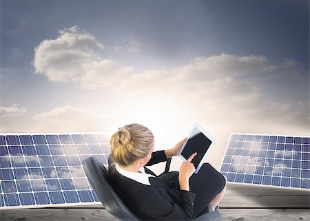 solar panels business - Composite image of blonde businesswoman sitting on swivel chair with tablet Stock Photo - Budget Royalty-Free & Subscription, Code: 400-07190014