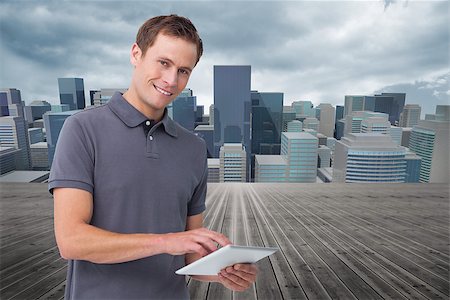 simsearch:400-06889355,k - Composite image of smiling young man with tablet computer Stockbilder - Microstock & Abonnement, Bildnummer: 400-07191719