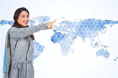 simsearch:400-07721096,k - Composite image of smiling brunette wearing winter clothes pointing out Stockbilder - Microstock & Abonnement, Bildnummer: 400-07191979