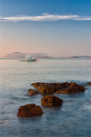 sonrisa sardónica - Yachts at sunrise on the Romazzino beach on Sardinia Stock Photo - Budget Royalty-Free & Subscription, Code: 400-07207290