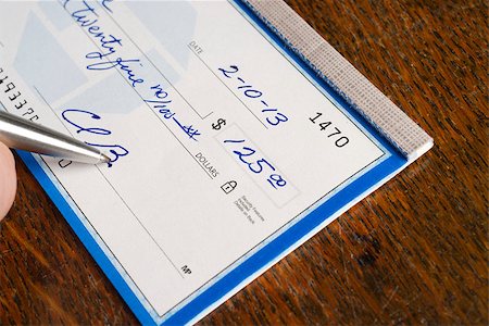 A Check is signed in ballpoint pen on the desk Stock Photo - Budget Royalty-Free & Subscription, Code: 400-07207481