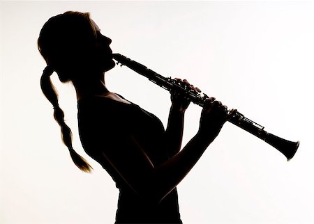 Female Musician Practices her Woodwind Technique on a Clarinet Photographed in silhouette Stock Photo - Budget Royalty-Free & Subscription, Code: 400-07207845