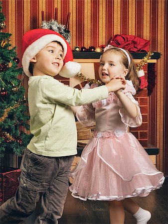 sister hugs baby - two beautiful child dancing near christmas tree Stock Photo - Budget Royalty-Free & Subscription, Code: 400-07208074
