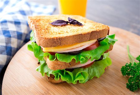 simsearch:400-07099478,k - Sandwich with ham, cheese, tomatoes and salad on toasted bread Stock Photo - Budget Royalty-Free & Subscription, Code: 400-07208387