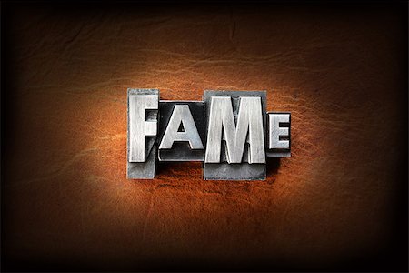 simsearch:400-07325569,k - The word fame made from vintage lead letterpress type on a leather background. Fotografie stock - Microstock e Abbonamento, Codice: 400-07208546