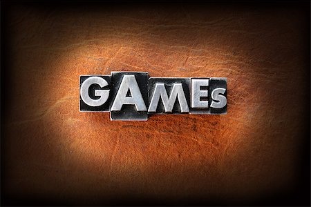 simsearch:400-07325569,k - The word games made from vintage lead letterpress type on a leather background. Fotografie stock - Microstock e Abbonamento, Codice: 400-07208553