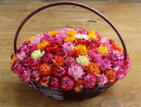 simsearch:400-04348779,k - wicker basket with multicolored flowers on wooden table Fotografie stock - Microstock e Abbonamento, Codice: 400-07208621